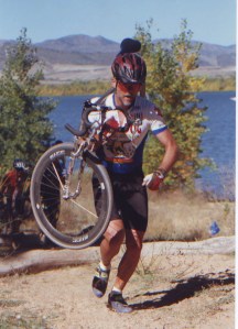 Your humble narrator in an earlier incarnation, racing at Chatfield. That's a titanium Voodoo Loa with V-brakes, a suspension fork and Zipp wheels. I had delusions of grandeur.