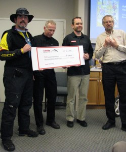 SRAM's Randy Neufeld (right) brought an early Christmas present to Bibleburg's bicycle advocates.