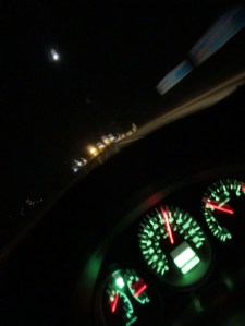 Through a windshield, darkly.